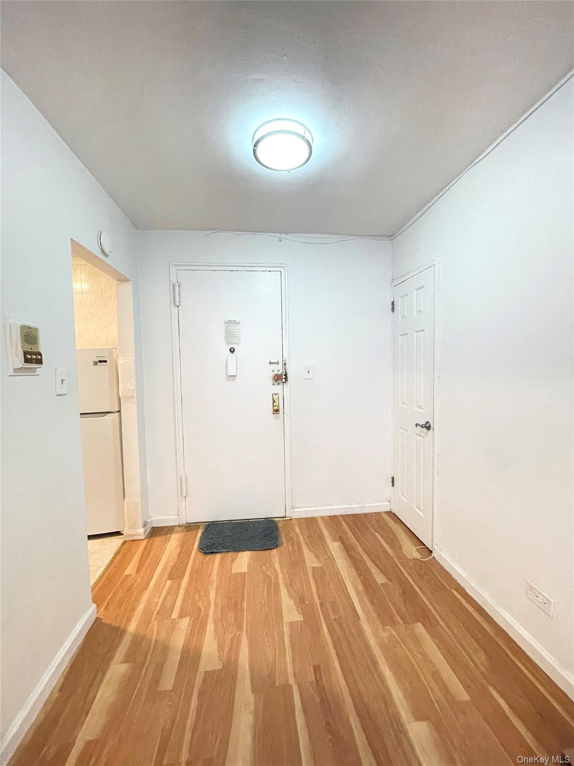 136-04 Cherry Avenue, Unit 3I Queens, NY 11355 - Photo 6 of 7 a view of a room with wooden floor