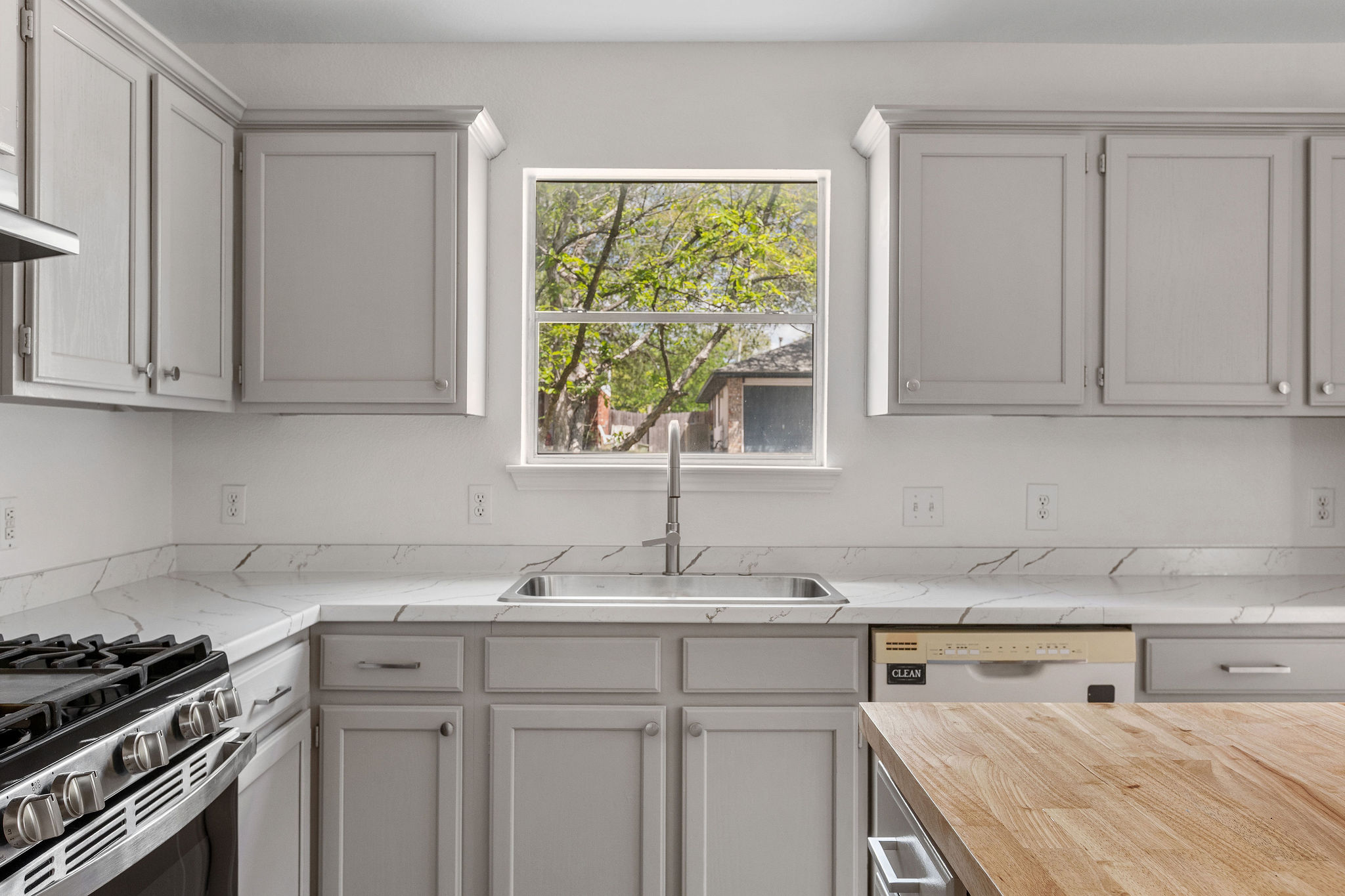 501 Shep Street Austin, TX 78748 - Photo 13 of 40 a kitchen with stainless steel appliances granite countertop a sink stove and cabinets