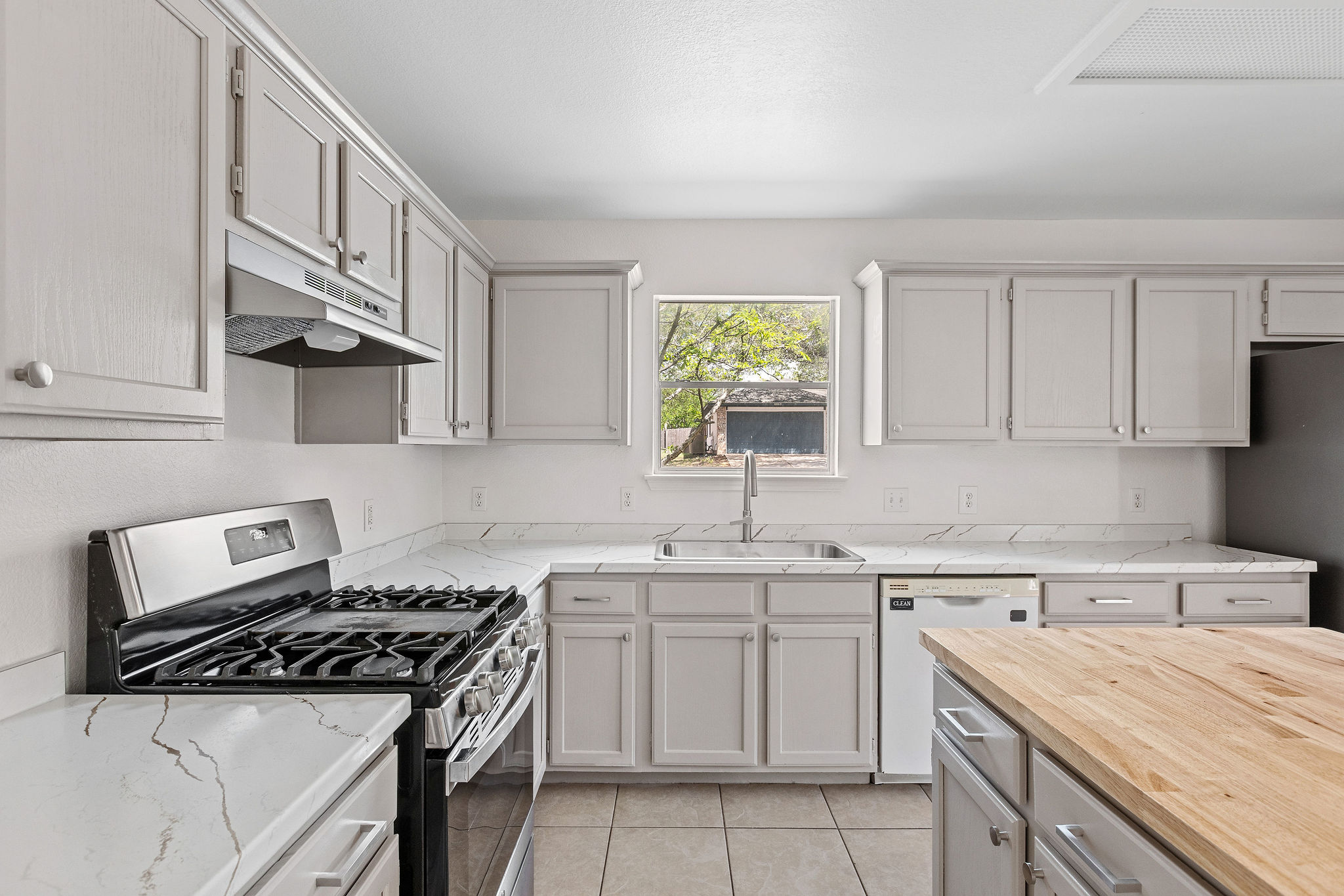 501 Shep Street Austin, TX 78748 - Photo 14 of 40 a kitchen with cabinets appliances a sink and a stove