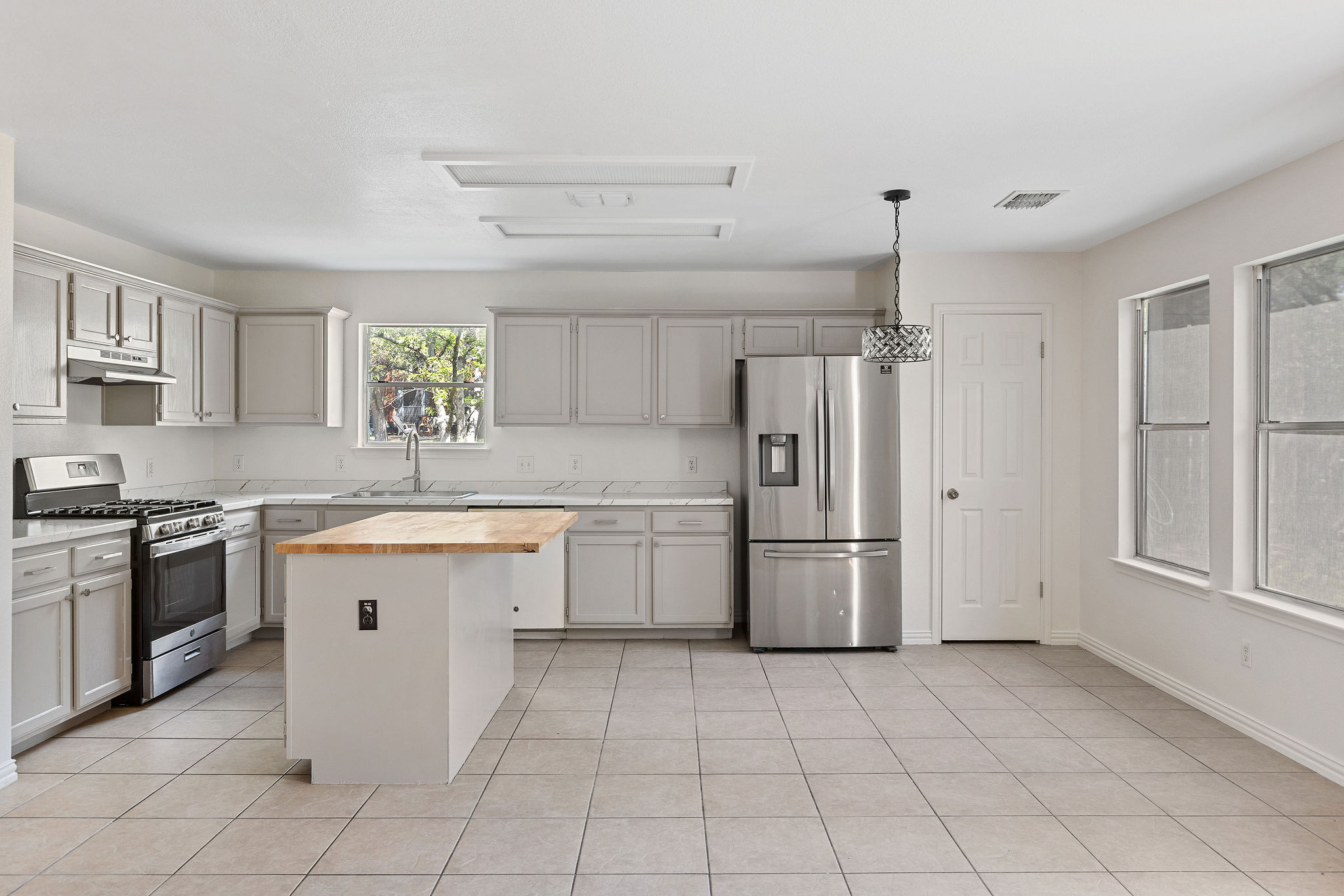 501 Shep Street Austin, TX 78748 - Photo 16 of 40 a kitchen with a stove top oven sink and refrigerator