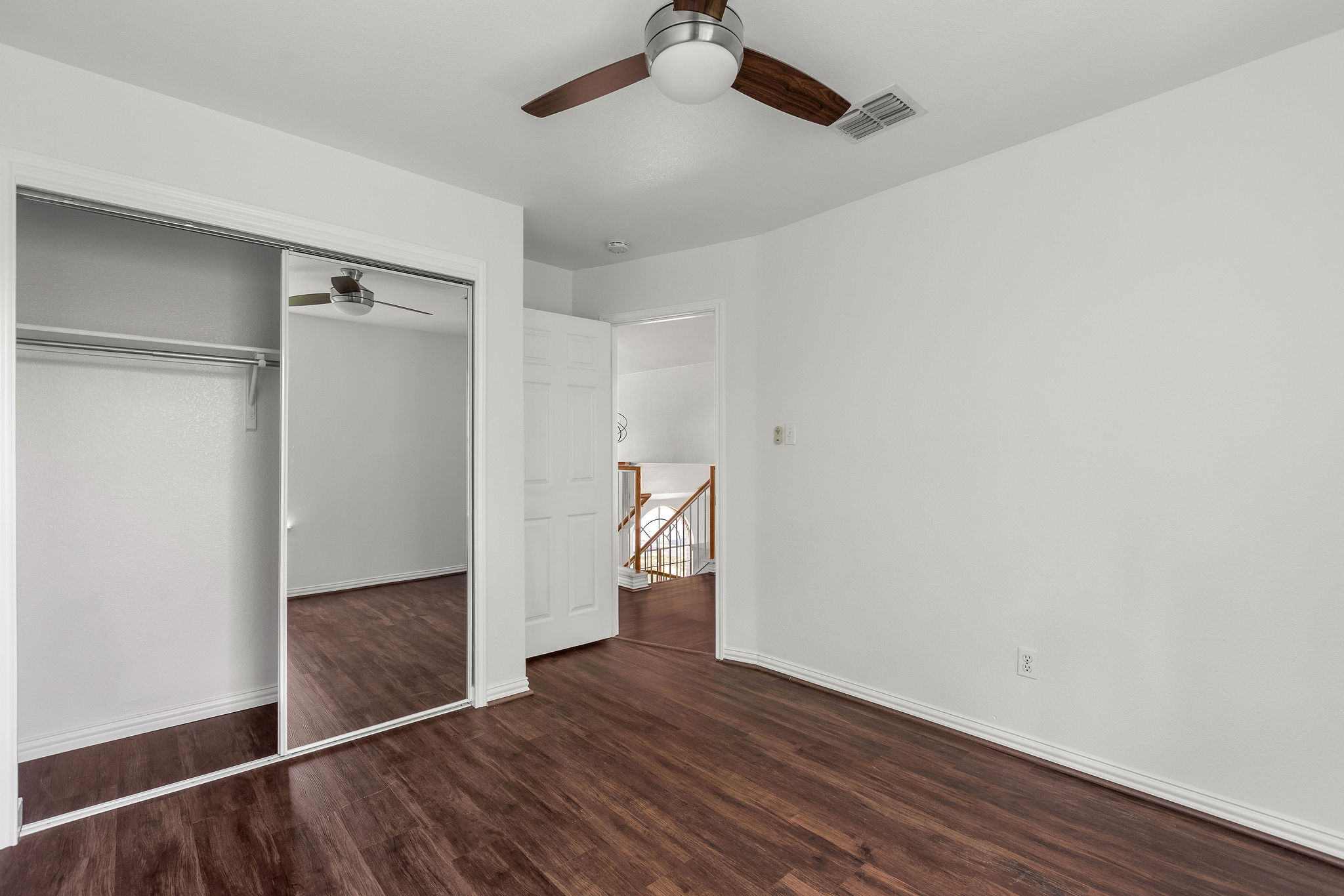 501 Shep Street Austin, TX 78748 - Photo 31 of 40 an empty room with wooden floor staircase and windows