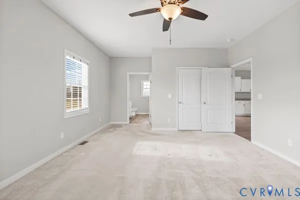 a bathroom with a granite countertop toilet a sink and a mirror