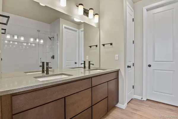 a bathroom with a sink double vanity granite and a mirror