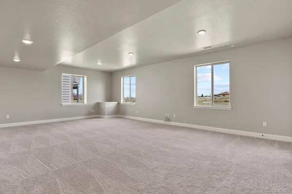 an empty room with windows and closet