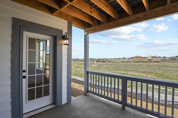 a view of a balcony next to a yard