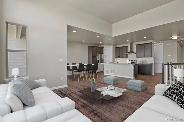 a living room with furniture and kitchen view