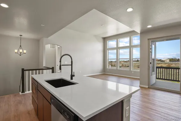 a view of kitchen with a sink and wooden floor
