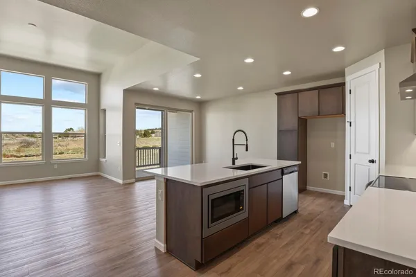 a kitchen with stainless steel appliances granite countertop a stove and a refrigerator