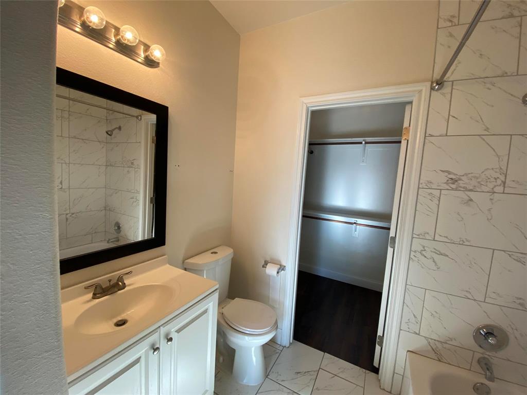3912 Avant Street Dallas, TX 75215 - Photo 12 of 27 a bathroom with a granite countertop sink toilet and shower