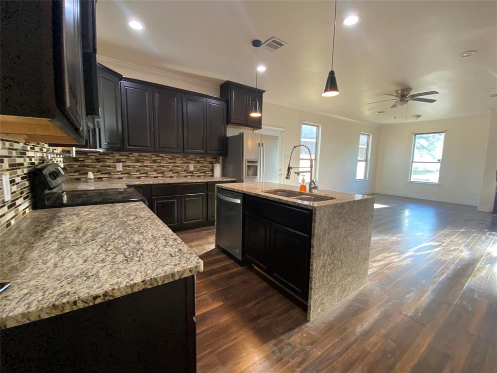 3912 Avant Street Dallas, TX 75215 - Photo 2 of 27 a kitchen with a stove and a refrigerator