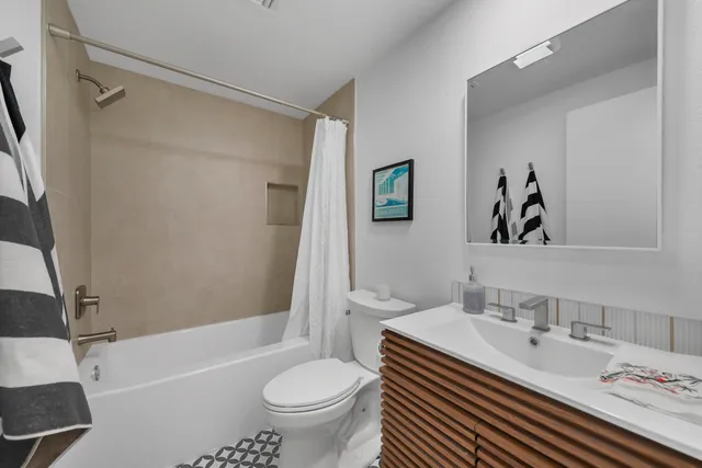 a bathroom with a sink toilet and shower