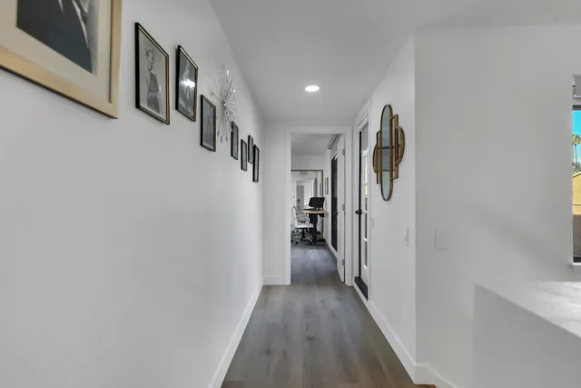 a bedroom with bed a table and chair