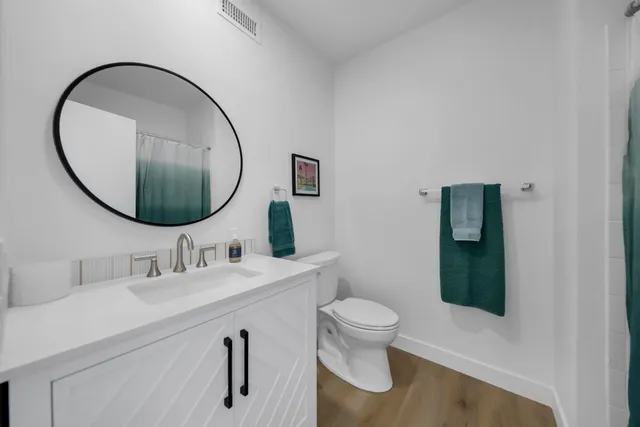 a roof deck with table and potted plants