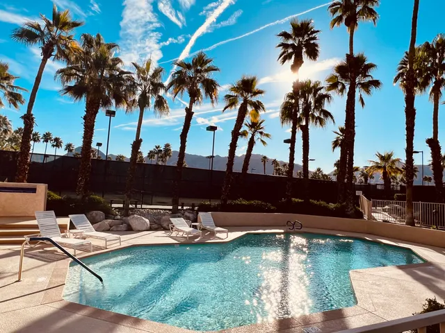 a view of house with swimming pool outdoor seating
