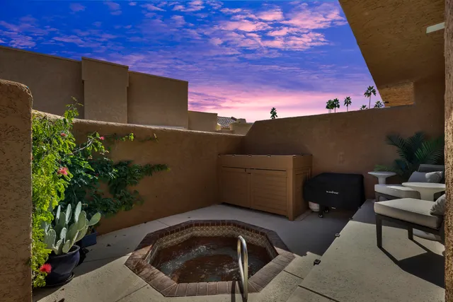a backyard of a house with table and chairs