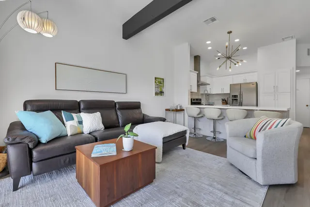a living room with furniture and a chandelier