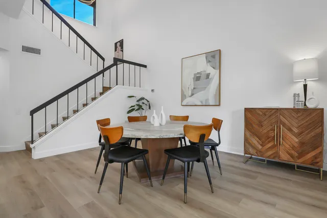 a view of a dining room with furniture and wooden floor