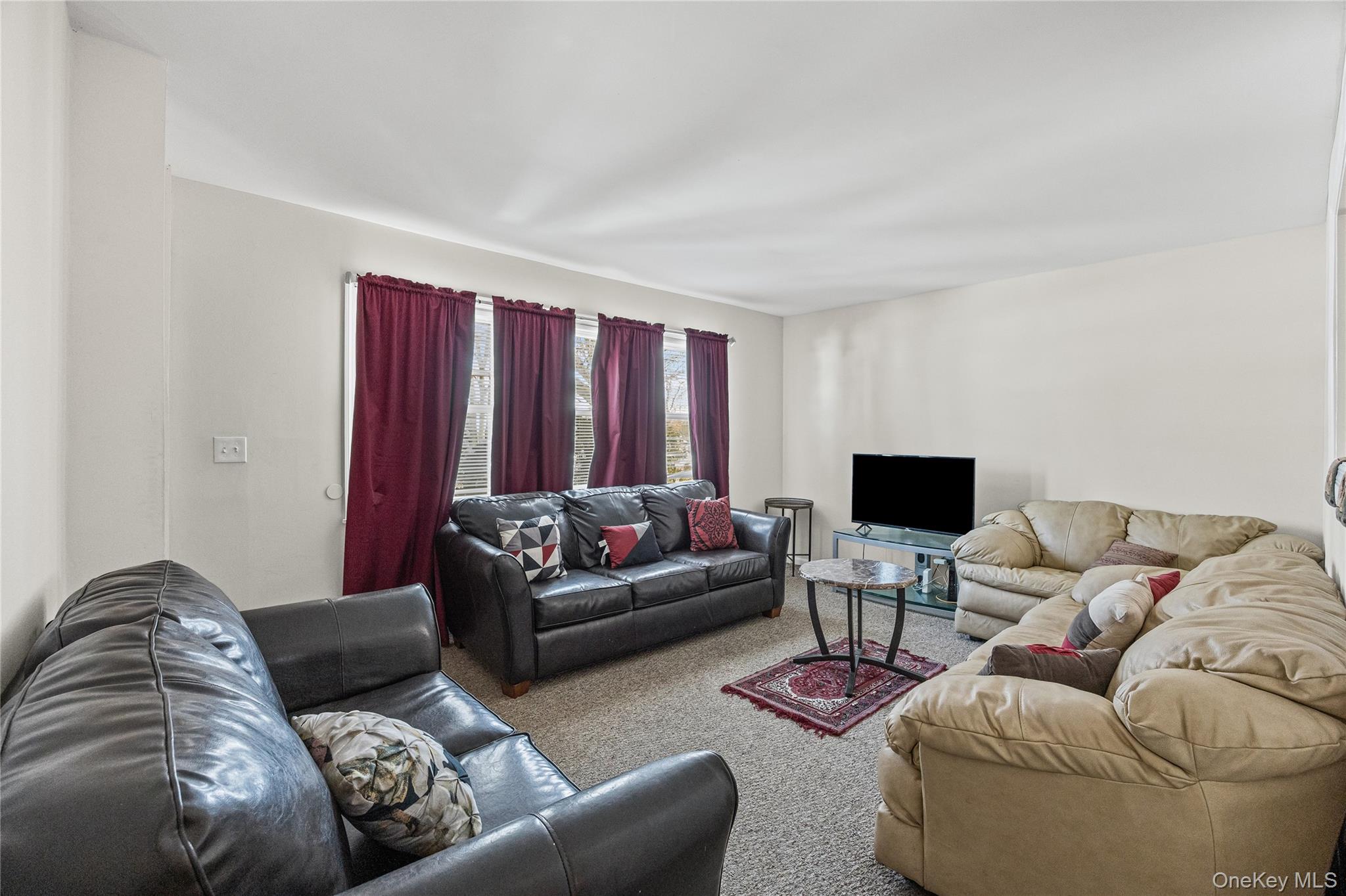 183 Mark Tree Road Centereach, NY 11720 - Photo 2 of 10 a living room with furniture and a couch