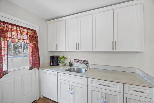 a kitchen with a sink cabinets and window