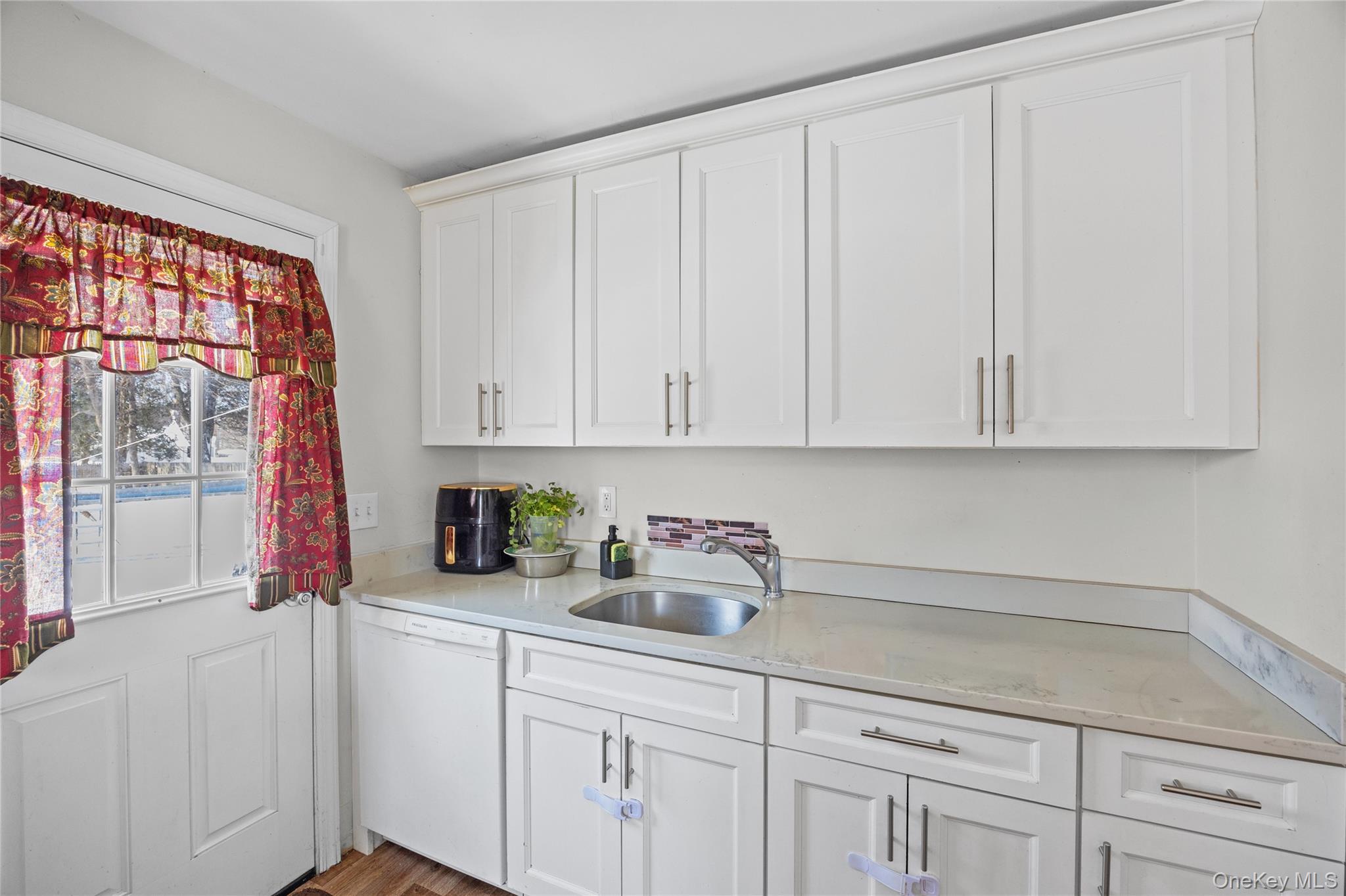 183 Mark Tree Road Centereach, NY 11720 - Photo 4 of 10 a kitchen with a sink cabinets and window