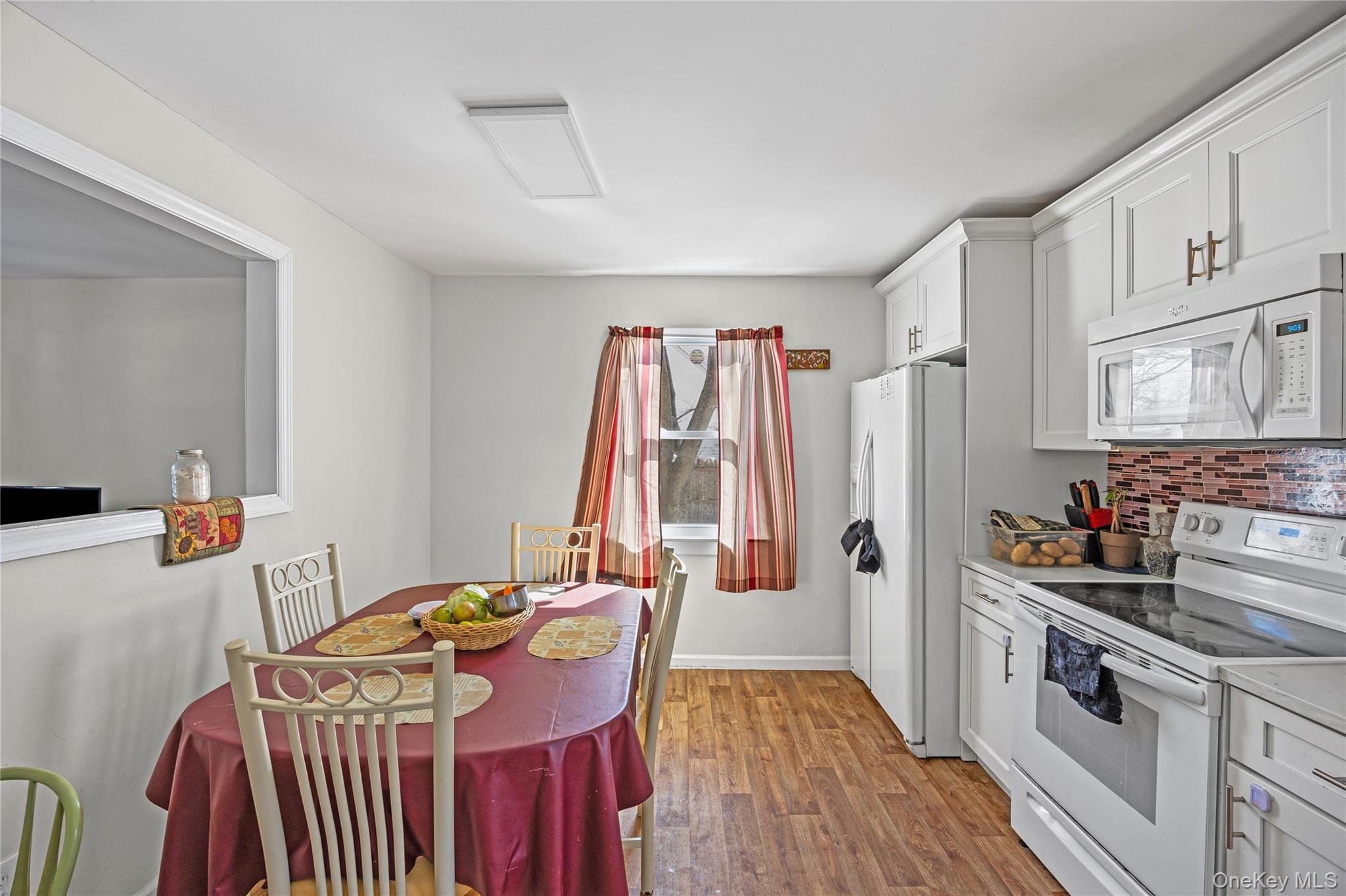 183 Mark Tree Road Centereach, NY 11720 - Photo 5 of 10 a view of a kitchen filled with furniture and wooden floor