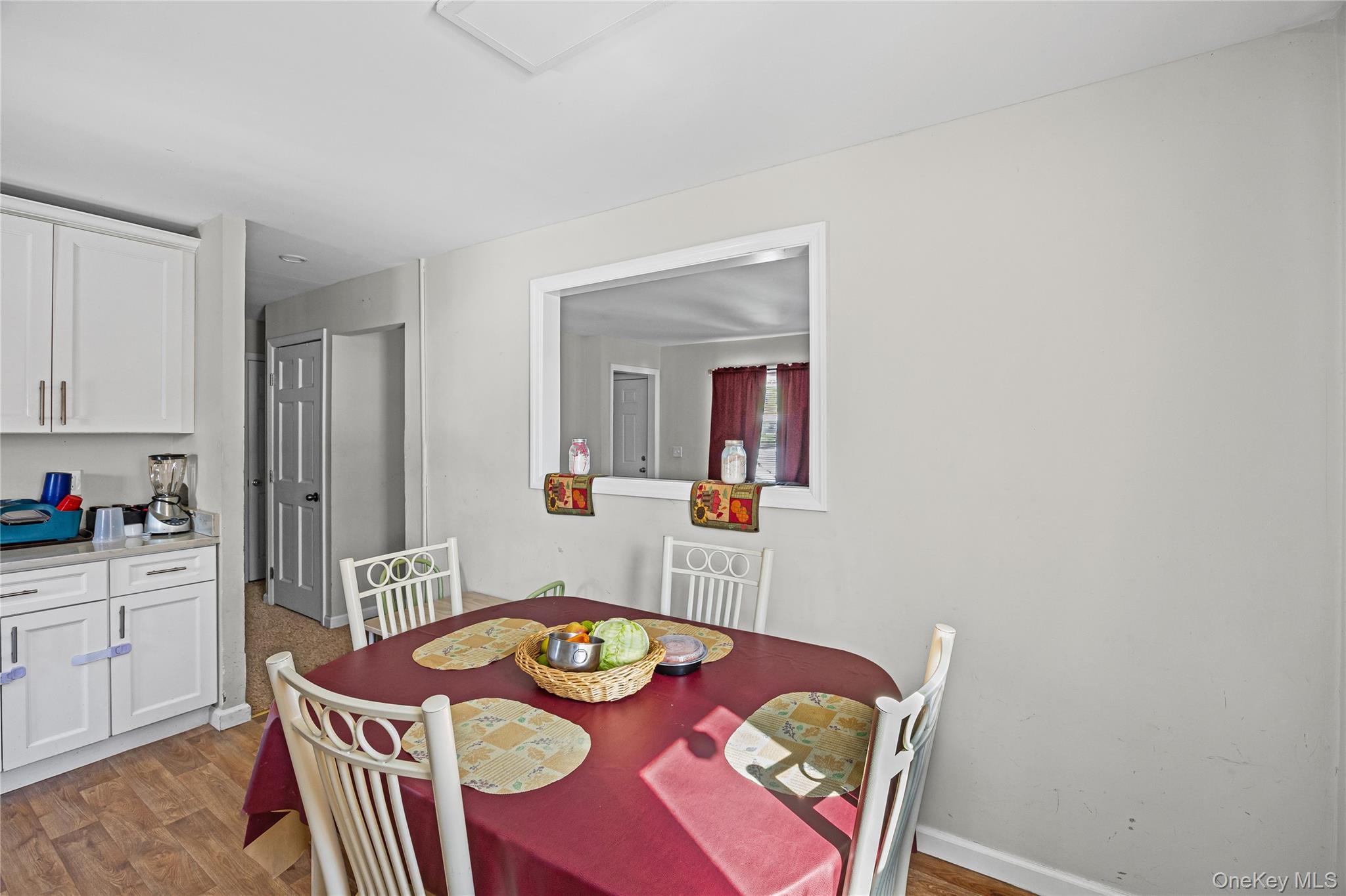 183 Mark Tree Road Centereach, NY 11720 - Photo 6 of 10 a dining room with furniture and wooden floor