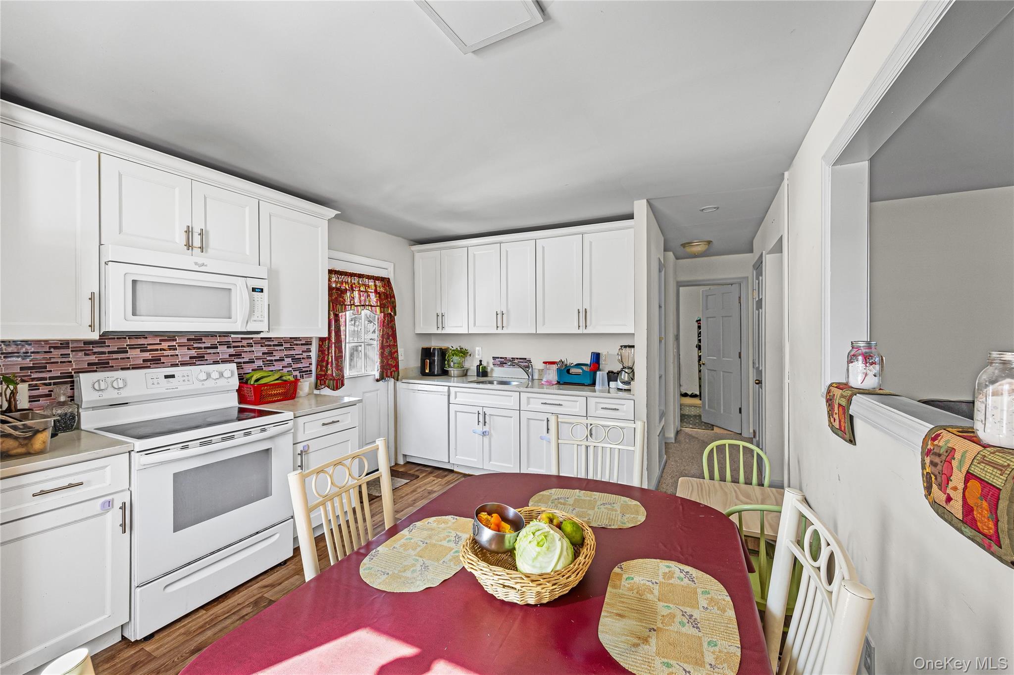 183 Mark Tree Road Centereach, NY 11720 - Photo 7 of 10 a kitchen that has cabinets a sink and white appliances