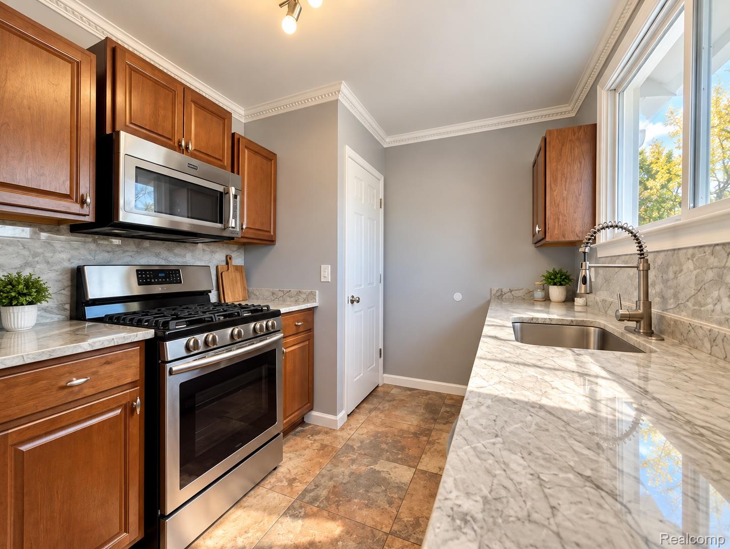 21761 Middlebelt Road Farmington, MI 48336 - Photo 5 of 21 Kitchen featuring stainless steel appliances, wood-finish cabinetry, stone countertops, and tile flooring