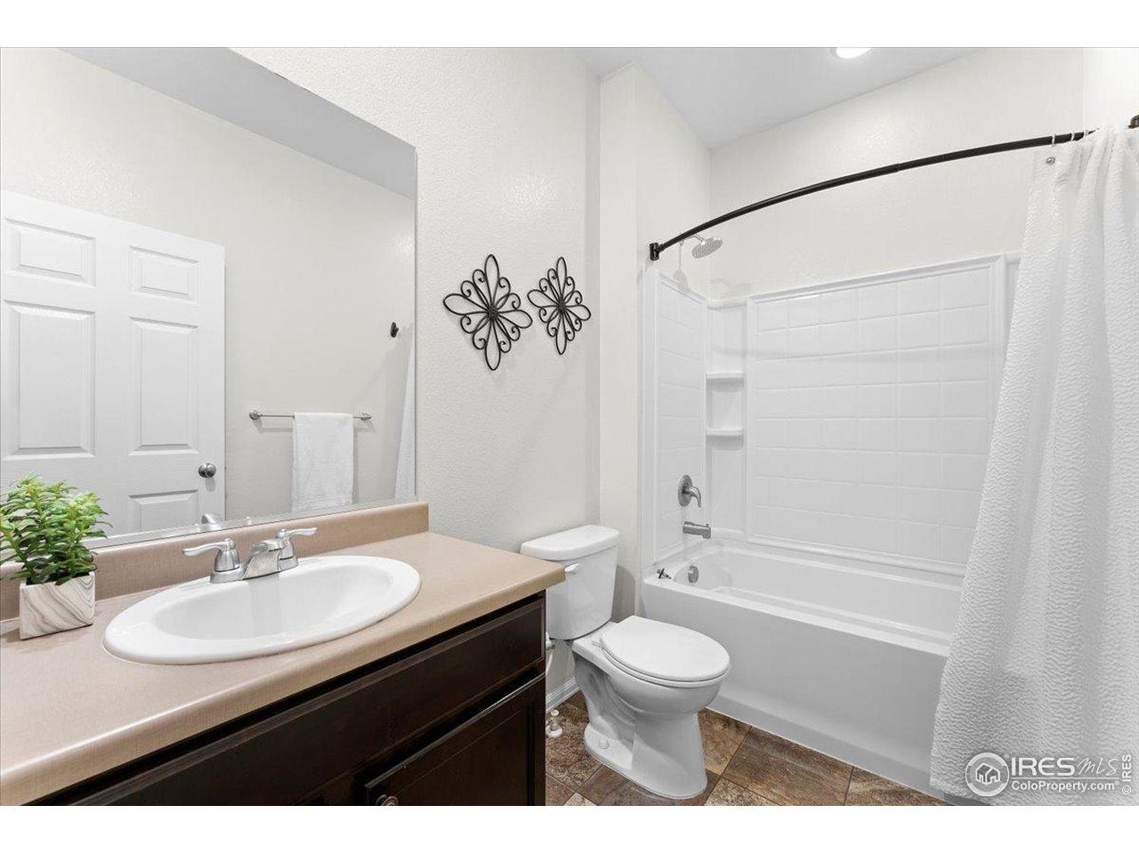 501 Buckrake Street Severance, CO 80550 - Photo 12 of 50 a bathroom with a sink toilet a shower and a mirror