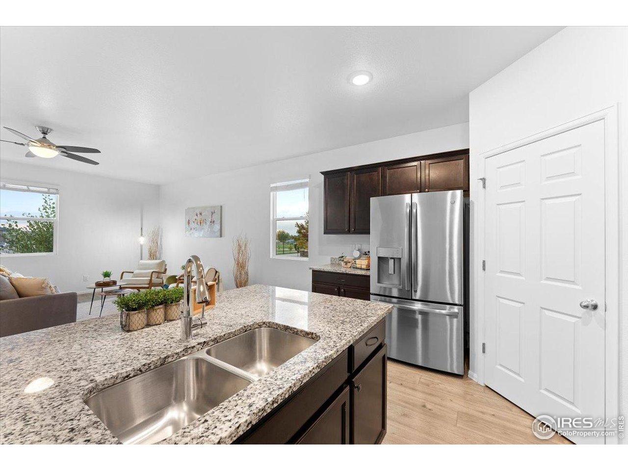 501 Buckrake Street Severance, CO 80550 - Photo 15 of 50 a kitchen with kitchen island a counter top space cabinets and stainless steel appliances