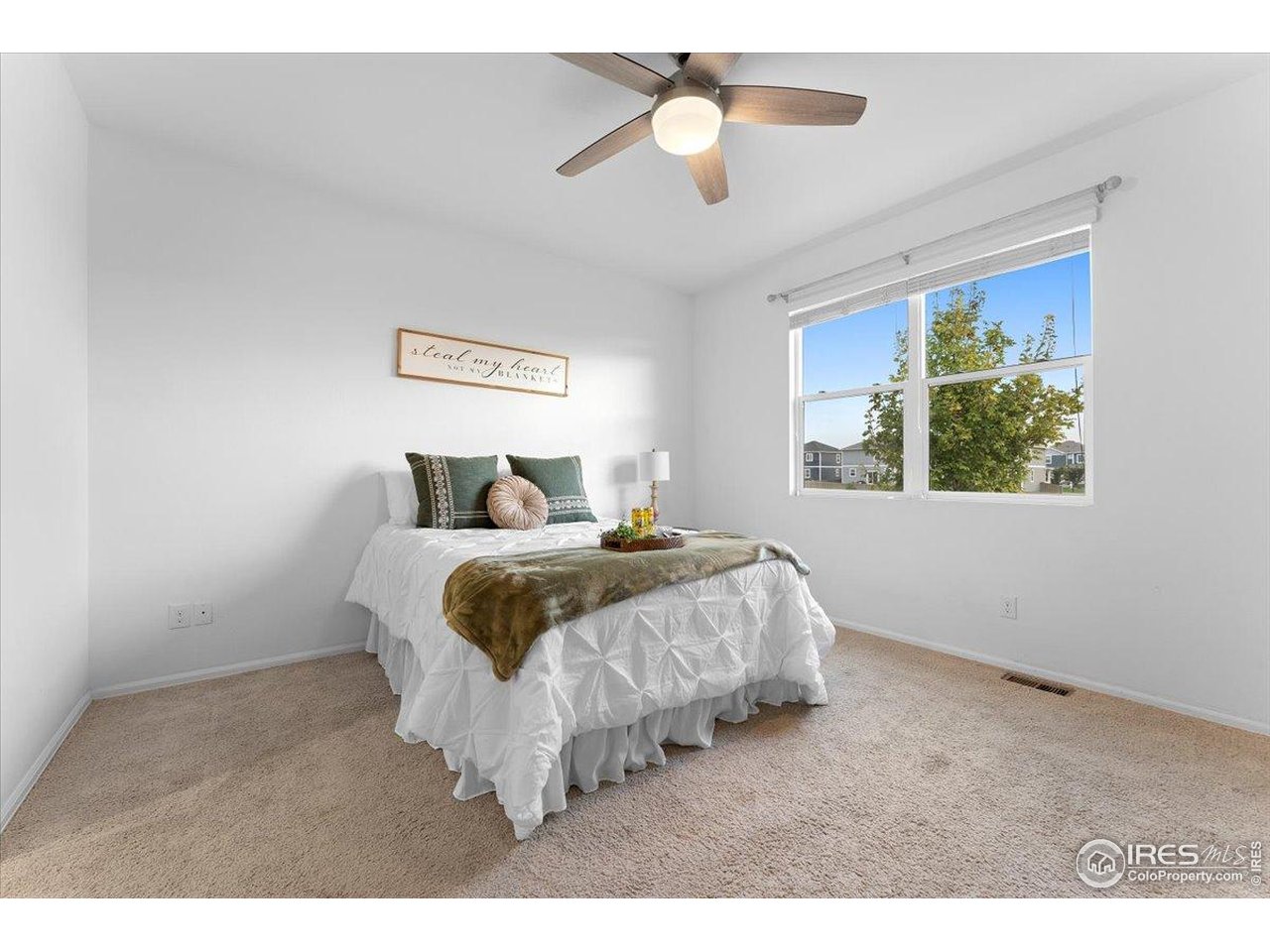 501 Buckrake Street Severance, CO 80550 - Photo 26 of 50 a bedroom with a bed and a painting on the wall