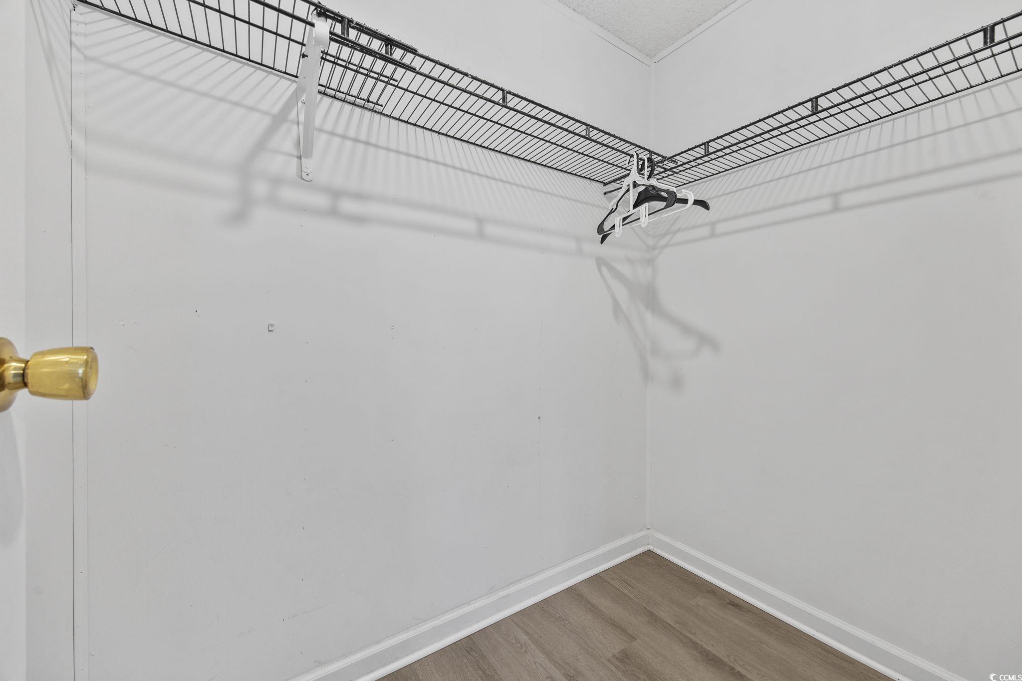 4221 Blake Road Myrtle Beach, SC 29588 - Photo 21 of 36 Walk in closet with wood finished floors