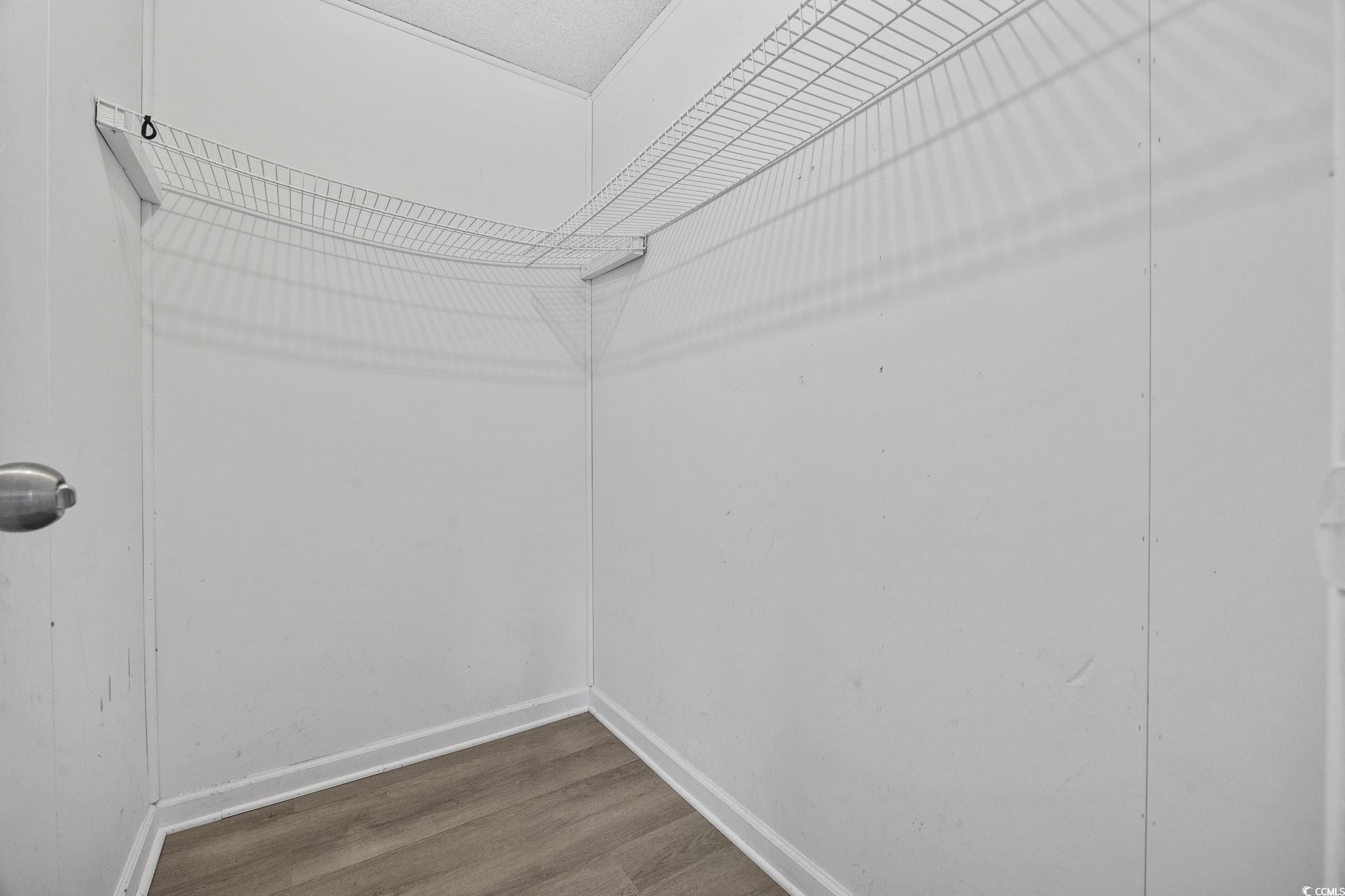 4221 Blake Road Myrtle Beach, SC 29588 - Photo 25 of 36 Walk in closet featuring wood finished floors