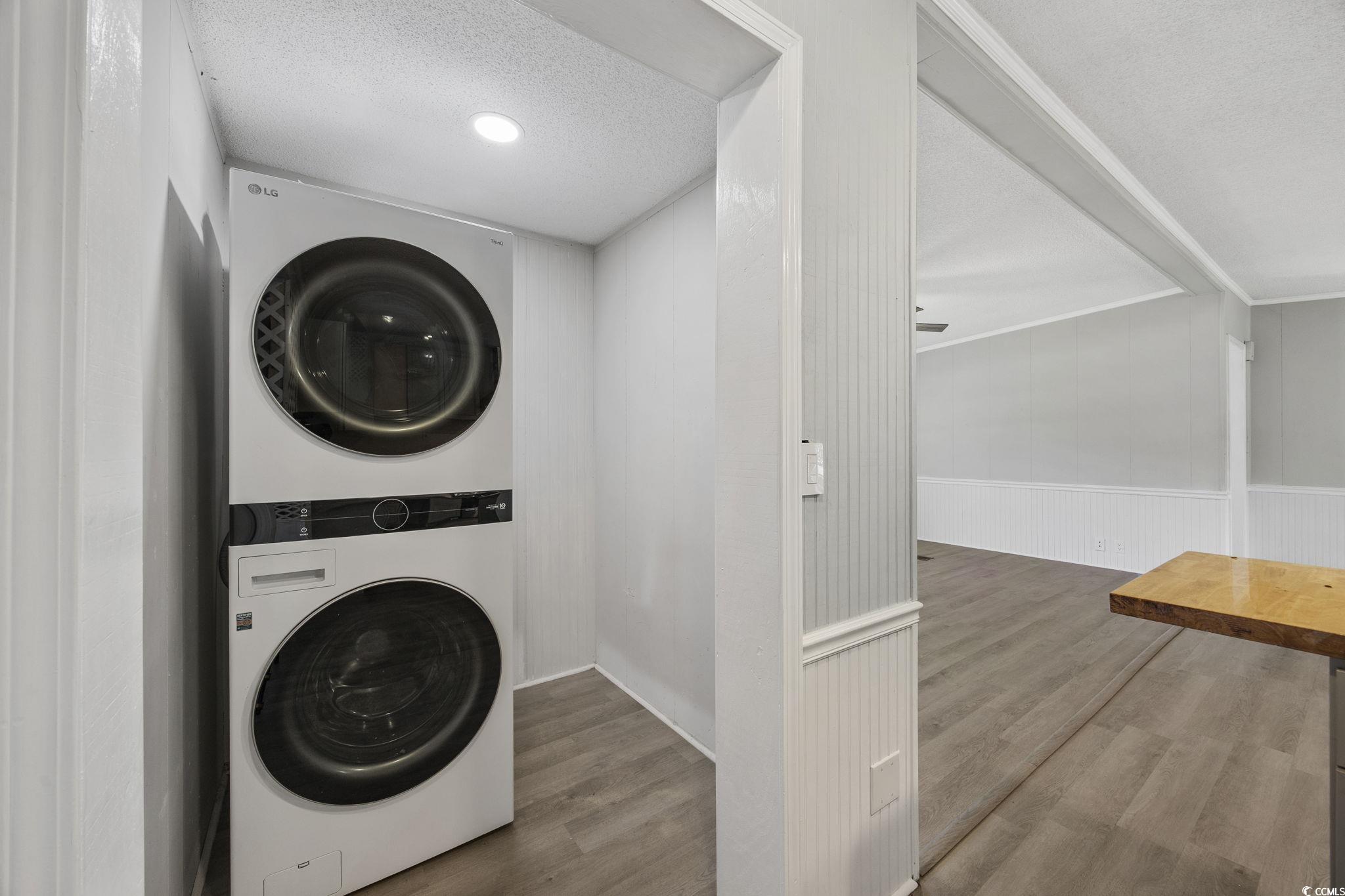 4221 Blake Road Myrtle Beach, SC 29588 - Photo 26 of 36 Laundry area with wood finished floors, a textured ceiling, and stacked washer / dryer