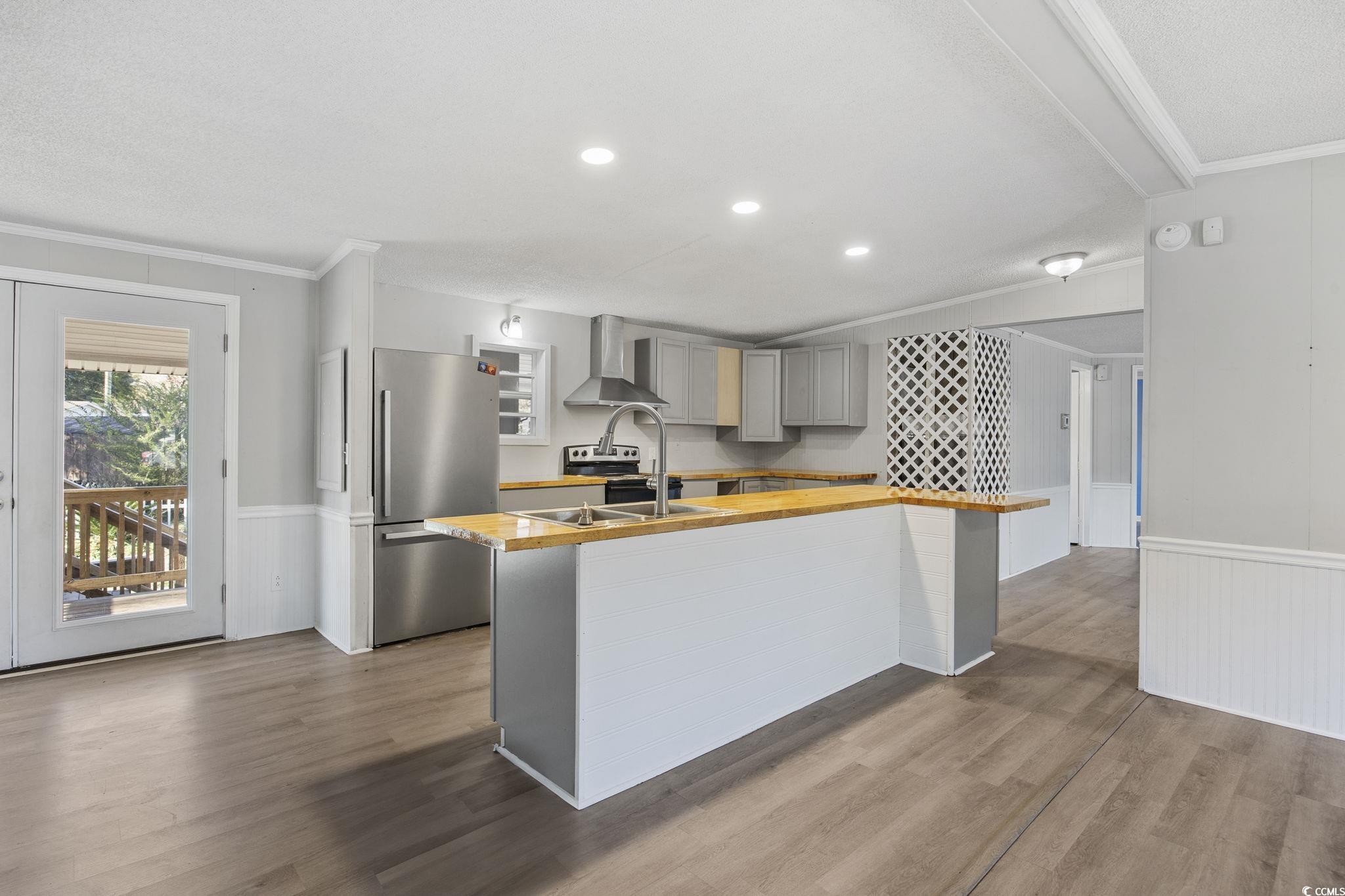 4221 Blake Road Myrtle Beach, SC 29588 - Photo 10 of 36 Kitchen featuring wainscoting, gray cabinetry, crown molding, stainless steel appliances, and dark wood-type flooring