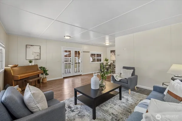 a living room with furniture and wooden floor