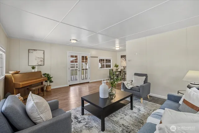 a living room with furniture and wooden floor