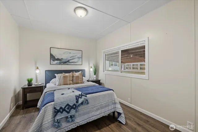 a bedroom with a bed and a painting on the wall