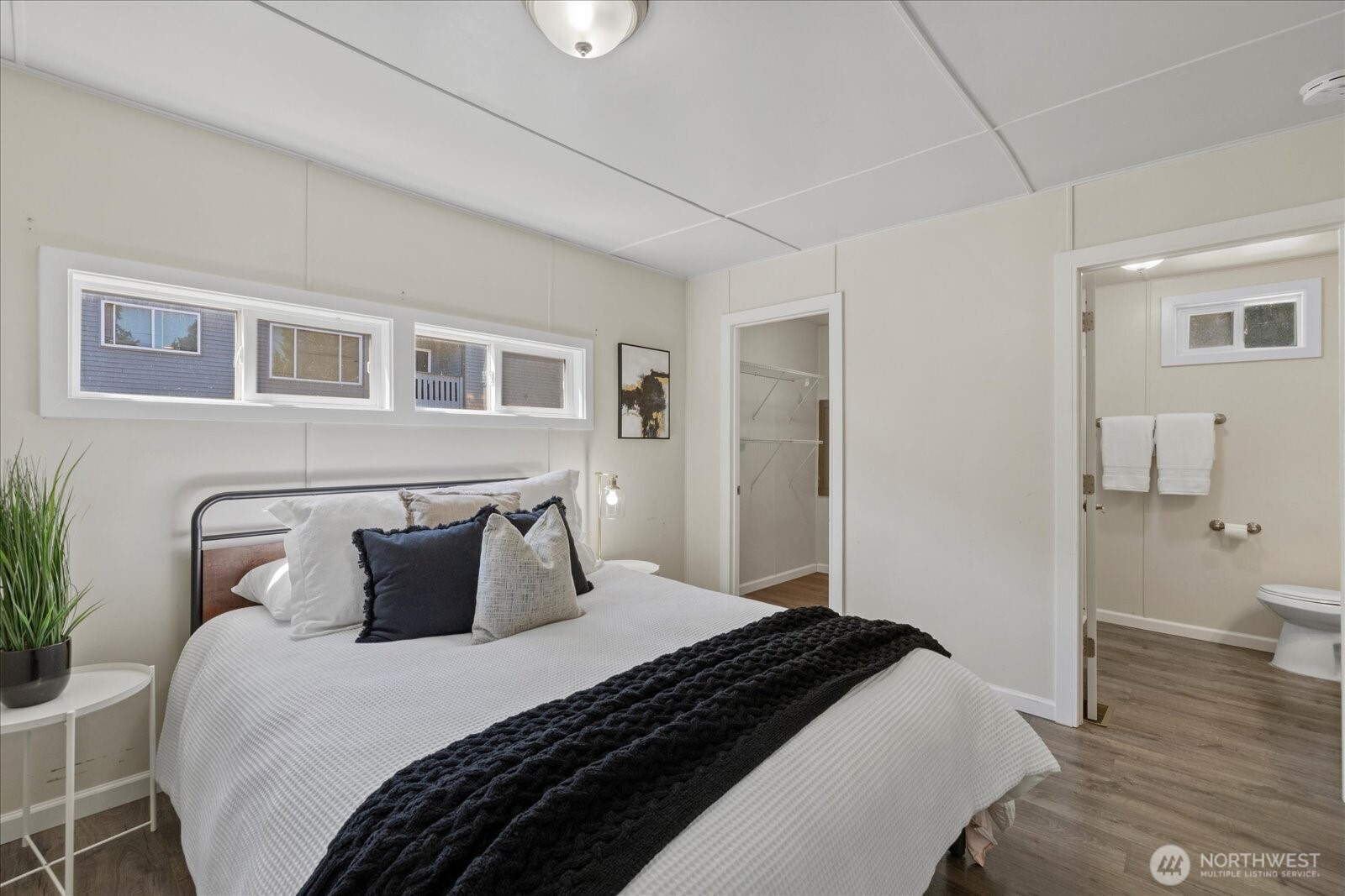 7301 Northeast 175th Street Kenmore, WA 98028 - Photo 23 of 28 a bedroom with a bed and wooden floor