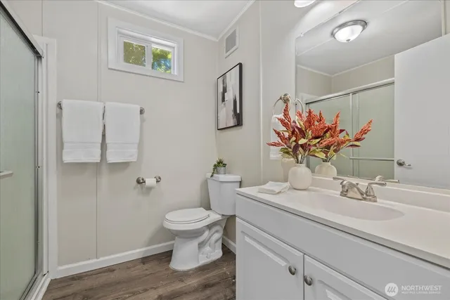 a bathroom with a sink mirror vanity and toilet