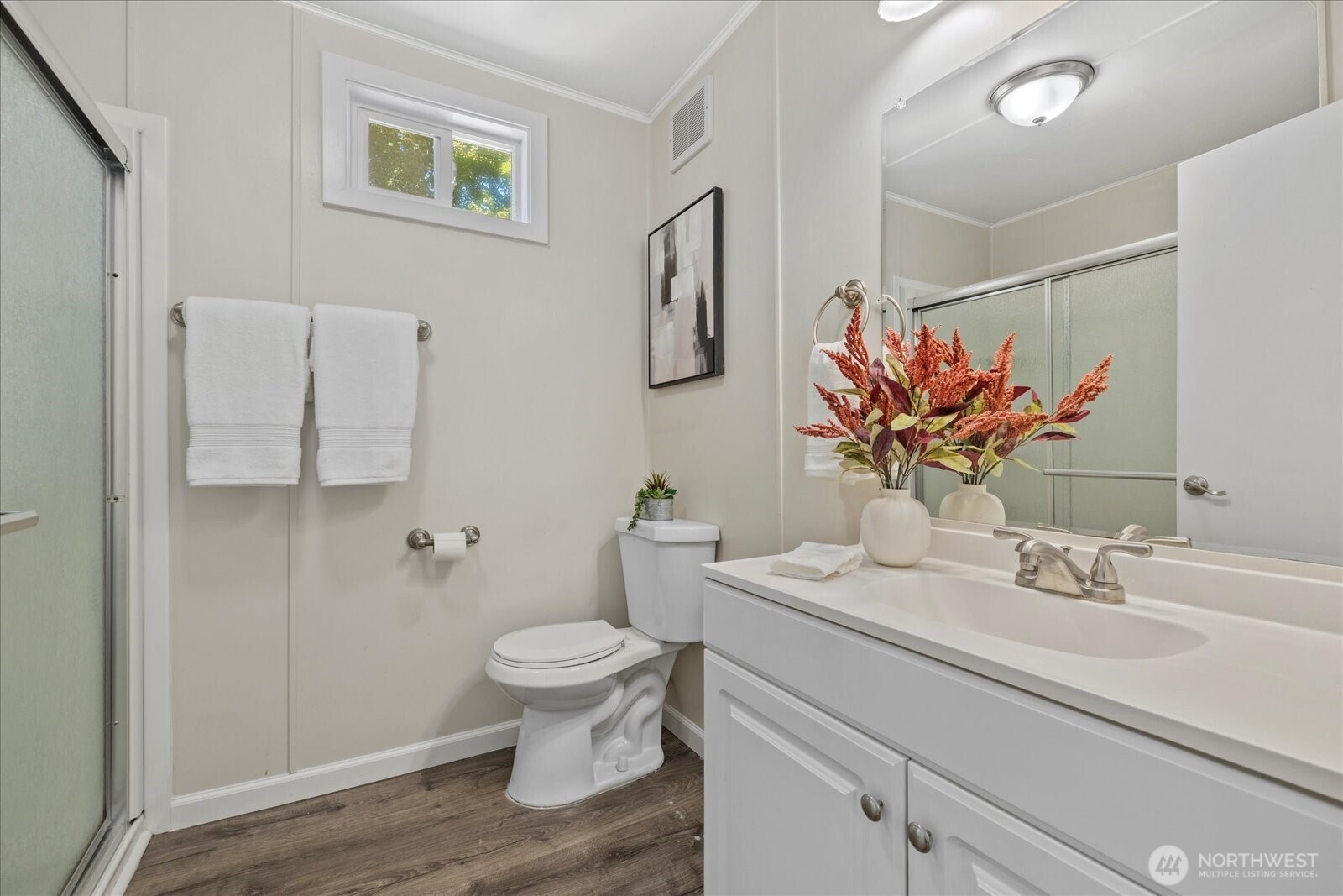 7301 Northeast 175th Street Kenmore, WA 98028 - Photo 25 of 28 a bathroom with a sink mirror vanity and toilet