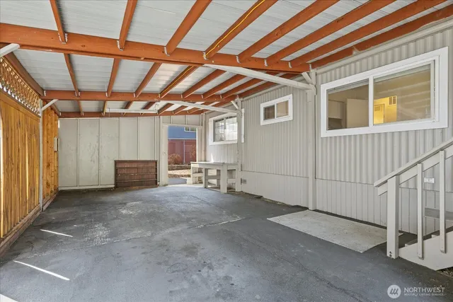 a view of a garage room with wooden walls