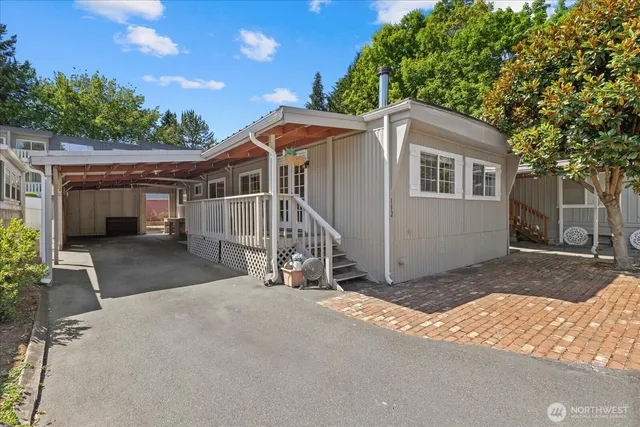 a view of a house with a yard and large tree