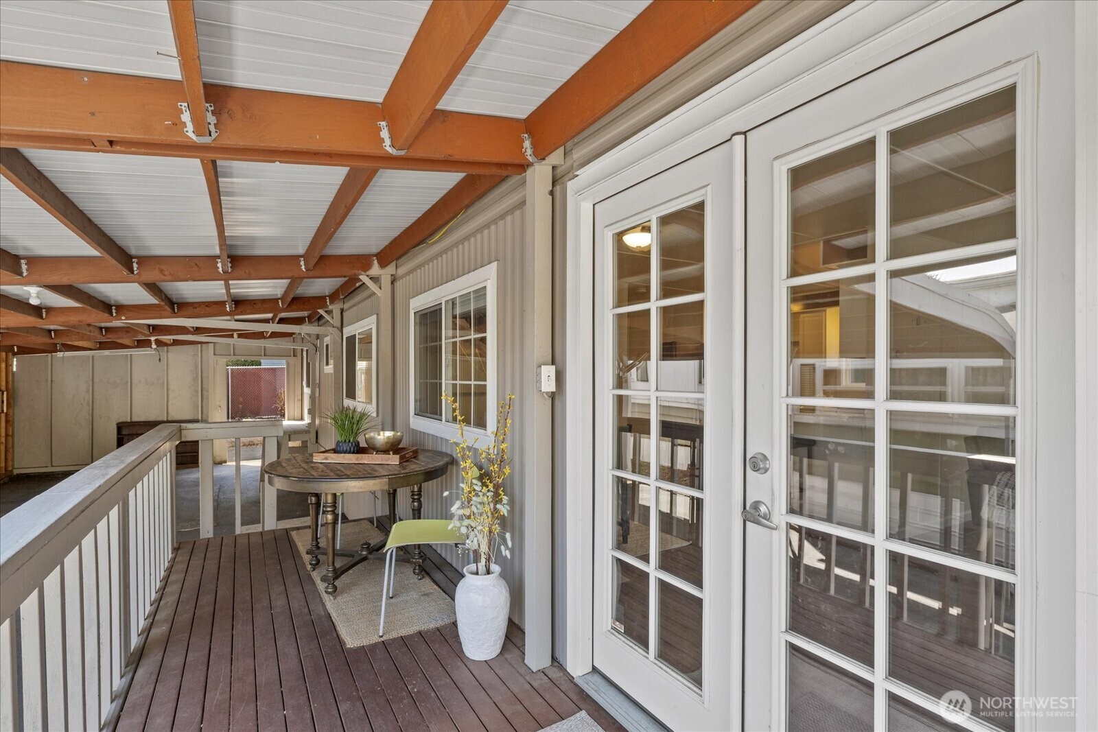 7301 Northeast 175th Street Kenmore, WA 98028 - Photo 8 of 28 a view of a deck with table and chairs with wooden floor