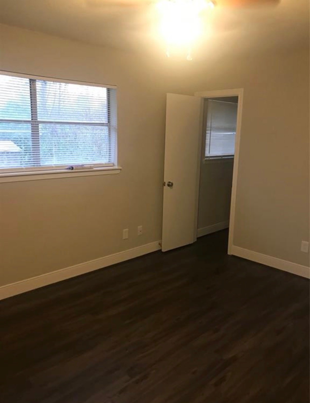 7230 England Street Houston, TX 77021 - Photo 12 of 15 a view of an empty room with wooden floor and a window