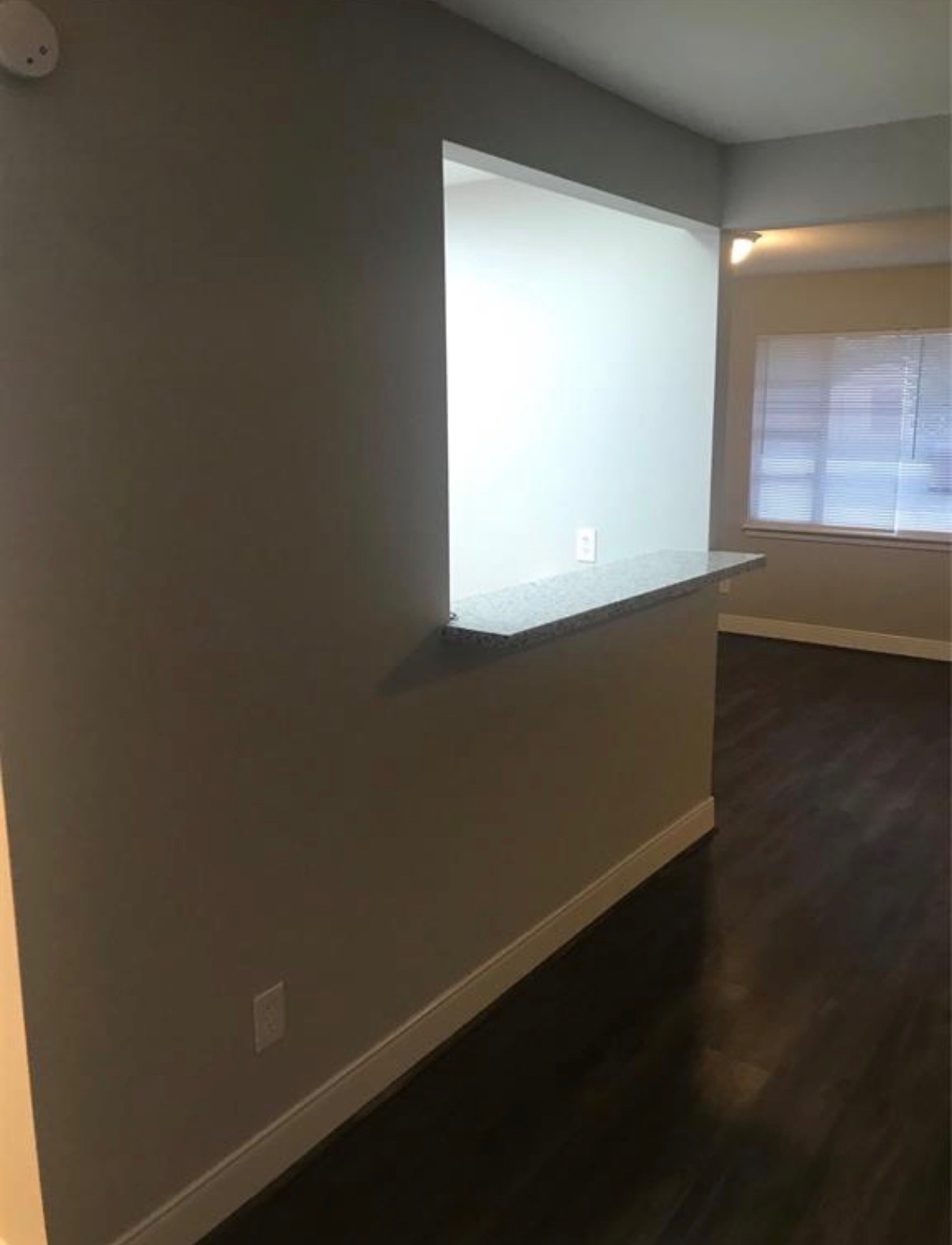 7230 England Street Houston, TX 77021 - Photo 4 of 15 a view of an empty room with wooden floor and a window