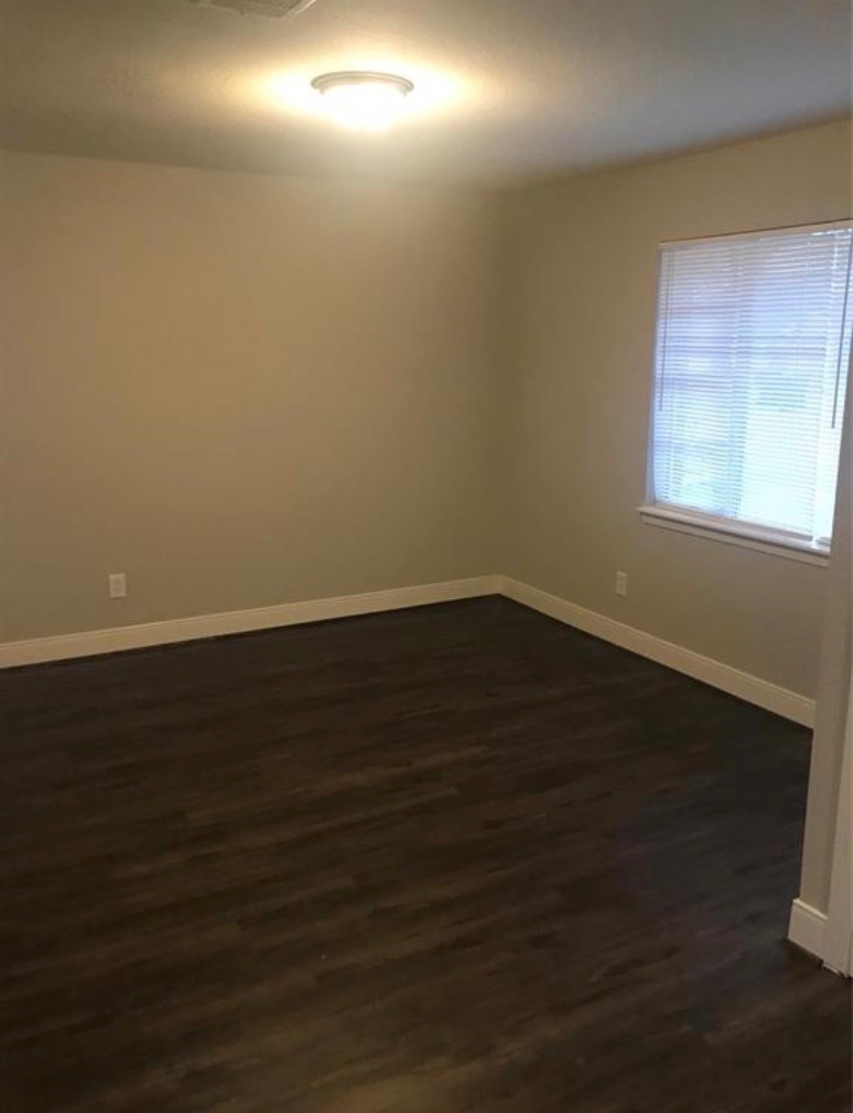 7230 England Street Houston, TX 77021 - Photo 6 of 15 an empty room with wooden floor and windows