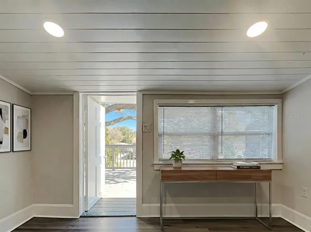 a room with wooden floor and a window