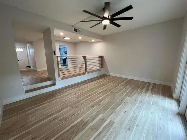 wooden floor in an empty room with a mirror