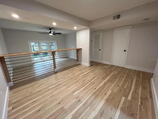 a view of a room with wooden floor